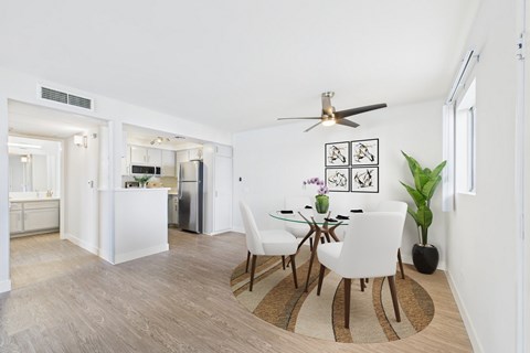 A dining room with a table and chairs.