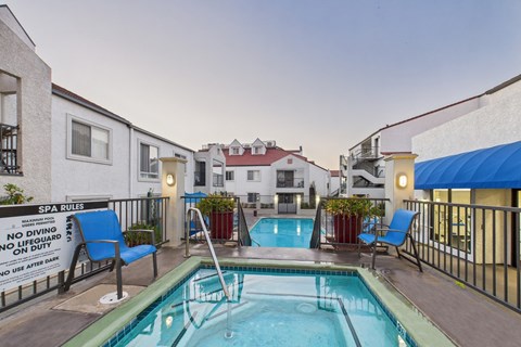 A pool with a sign that says spa rules.