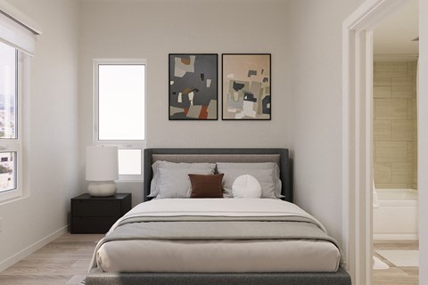 A bedroom with a large bed and two abstract paintings on the wall.