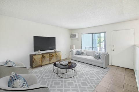 A living room with a television, sofa, and coffee table.