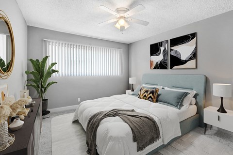 a bedroom with a bed and a ceiling fan