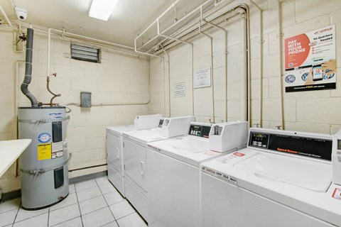 a laundry room with four washers and four washing machines