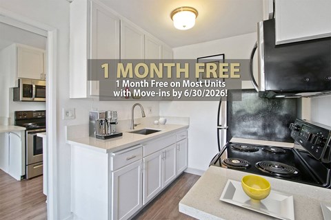 A kitchen with a promotion for a free month on most units with a move-in by a certain date.