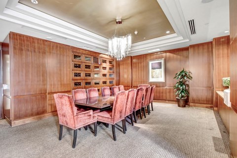 a dining room with a table and chairs and a chandelier