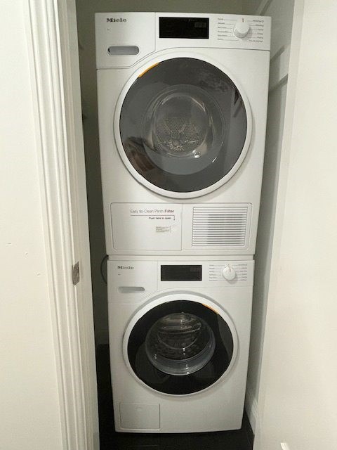 A white dryer and washer stacked on top of each other.
