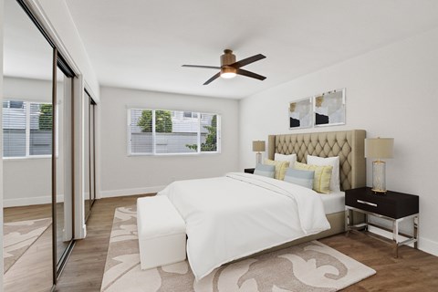 A bedroom with a large bed and a ceiling fan.