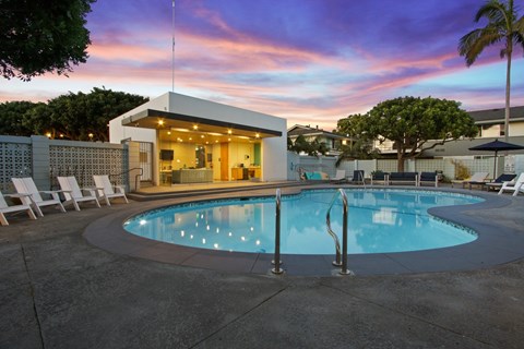 A pool with a building behind it.
