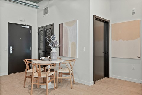 a dining area with a round table and four chairs