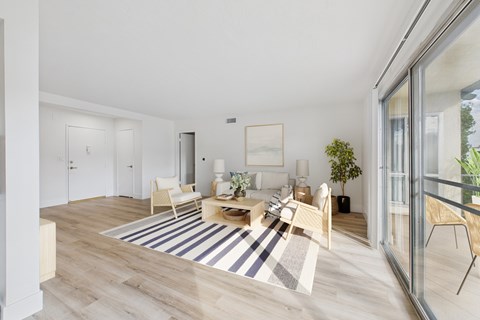 A living room with a white couch and a coffee table.