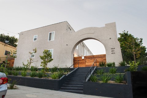 a building with an arch and stairs in front of it