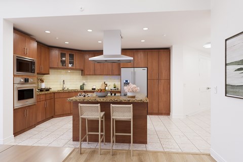 A modern kitchen with wooden cabinets and a central island.