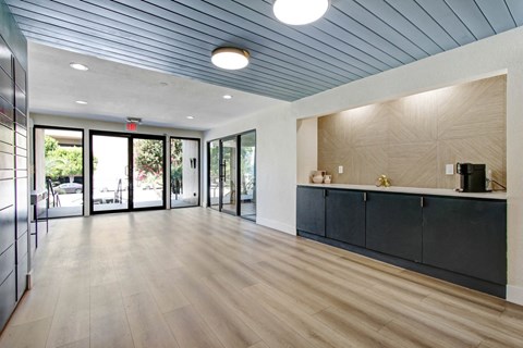 a lobby with a blue ceiling and wood flooring