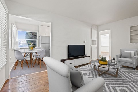 A living room with a grey sofa and a wooden coffee table.