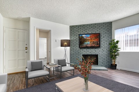 A living room with a fireplace and a painting on the wall.