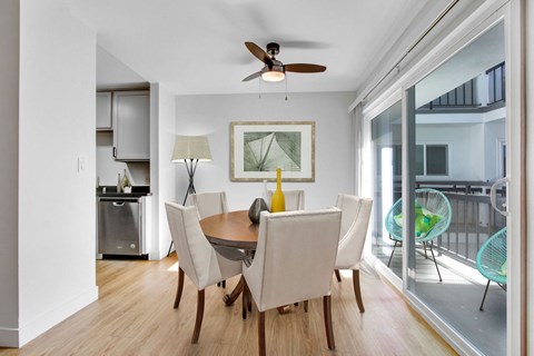 A dining room with a table and chairs.