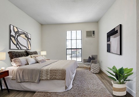 a bedroom with a large bed and a large window
