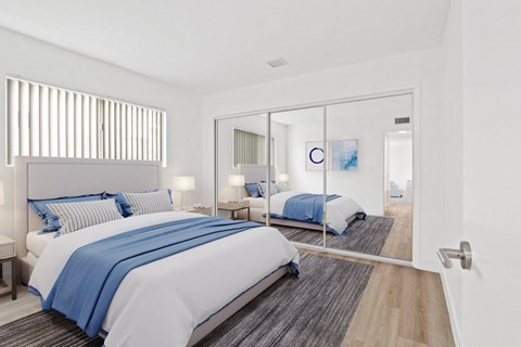 a bedroom with two beds and a sliding glass door