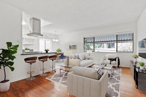 A living room with a white couch and a bar area.