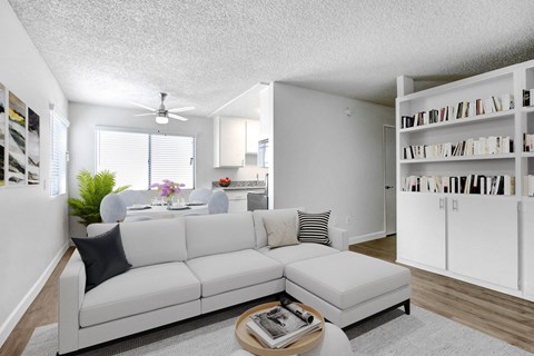 A living room with a white couch and a coffee table.