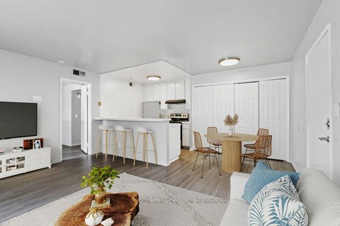A modern living room with a white couch and a wooden coffee table.