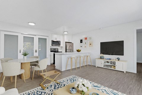 A modern kitchen with a dining table and chairs.