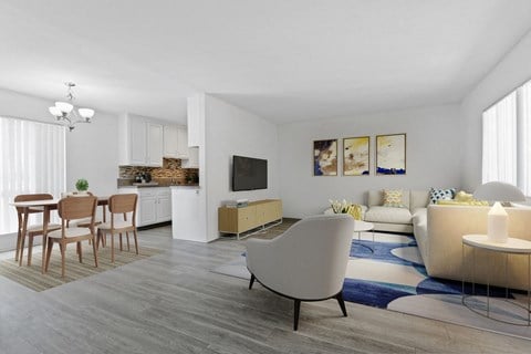 A modern living room with a white couch and a white chair.