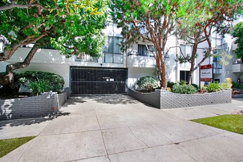 a gated driveway in front of an apartment building