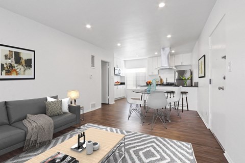 A modern living room with a grey sofa and a coffee table.