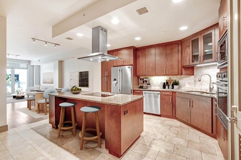 A kitchen with wooden cabinets and a large island.