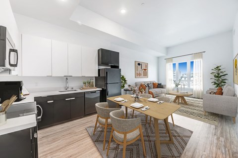 A modern kitchen with a dining table and chairs.