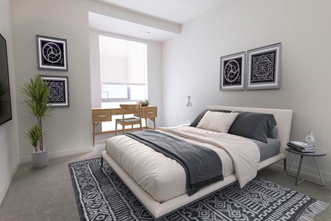 A bedroom with a large bed and a TV on the wall.