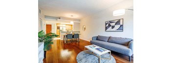 a living room with a couch and a table at Wilshire Margot, Los Angeles, CA