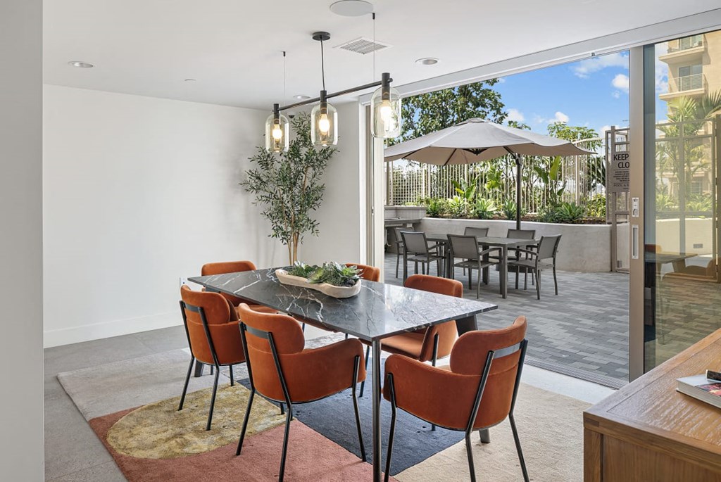 a dining room with a table and chairs and a patio