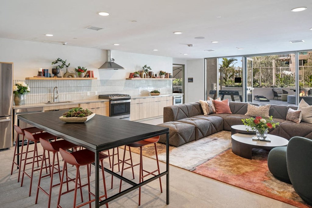 a large living room with a kitchen and a table and chairs