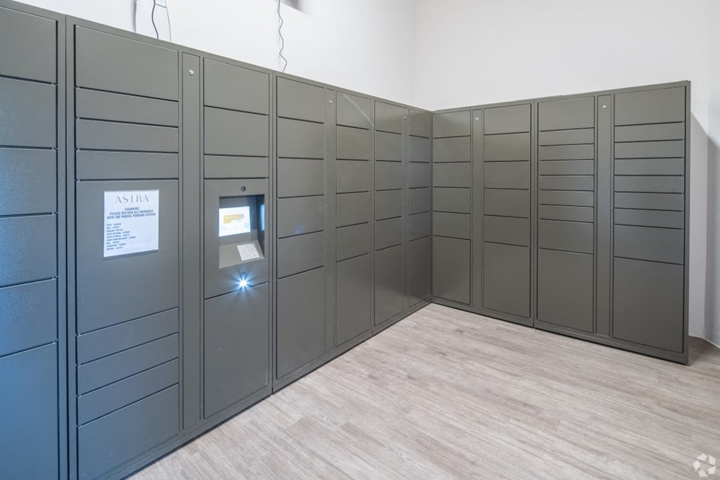 a room filled with gray lockers and a wooden floor