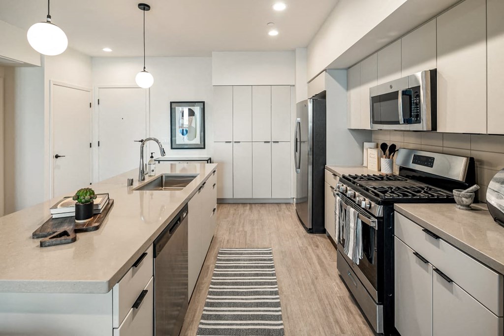 a kitchen with stainless steel appliances and white cabinets