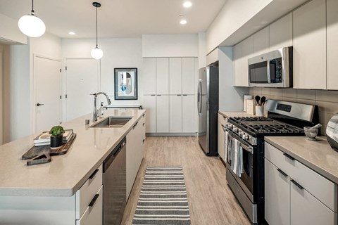 a kitchen with stainless steel appliances and white cabinets