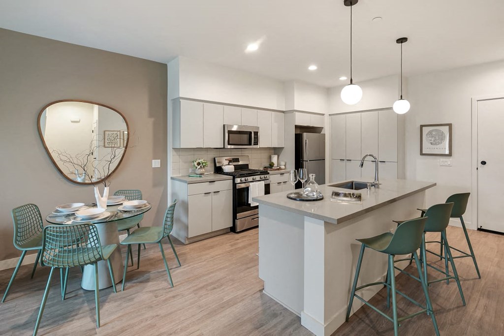an open kitchen and dining area with a table and chairs