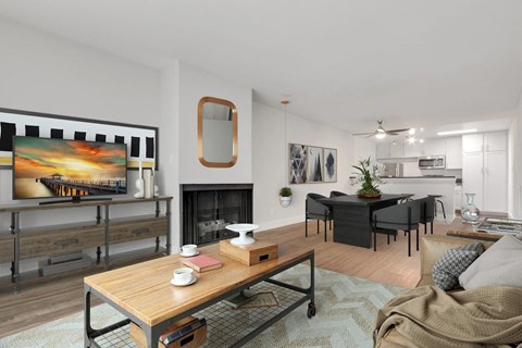 A modern living room with a fireplace and a painting on the wall.