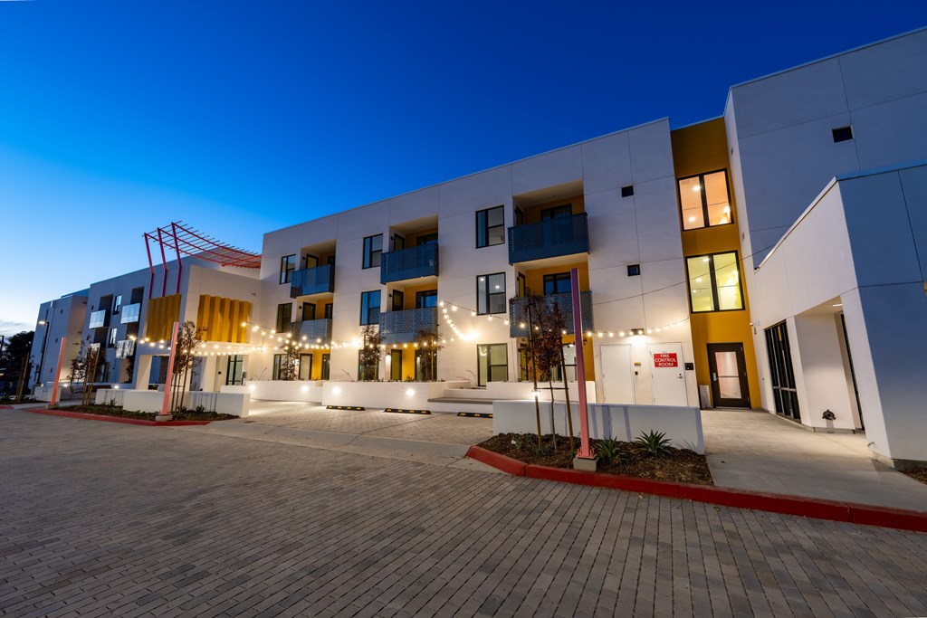 A modern building with a parking lot in front.