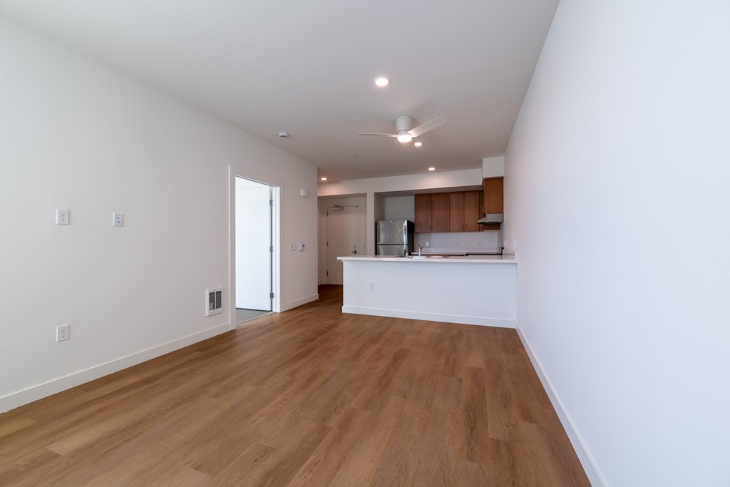 A room with wooden floors and white walls.