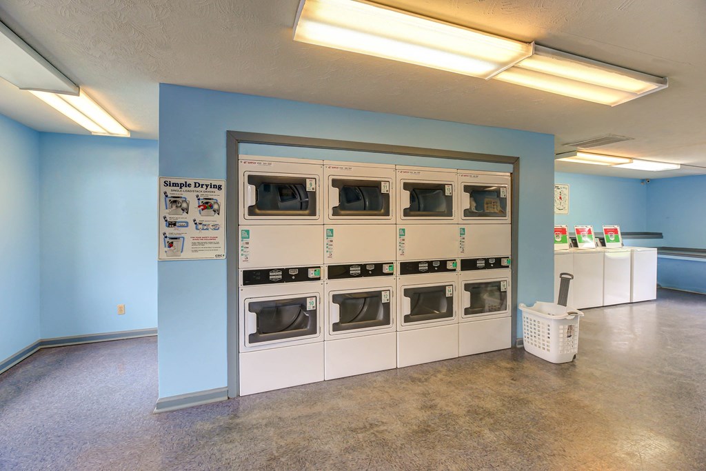 a wall of microwaves in a room with blue walls