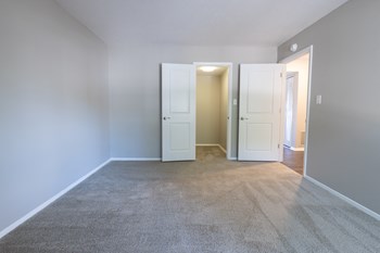 Primary Bedroom with a Walk-in Closet in the Two Bedroom One Bath Apartment at Woodbridge Apartments Bloomington - Photo Gallery 56