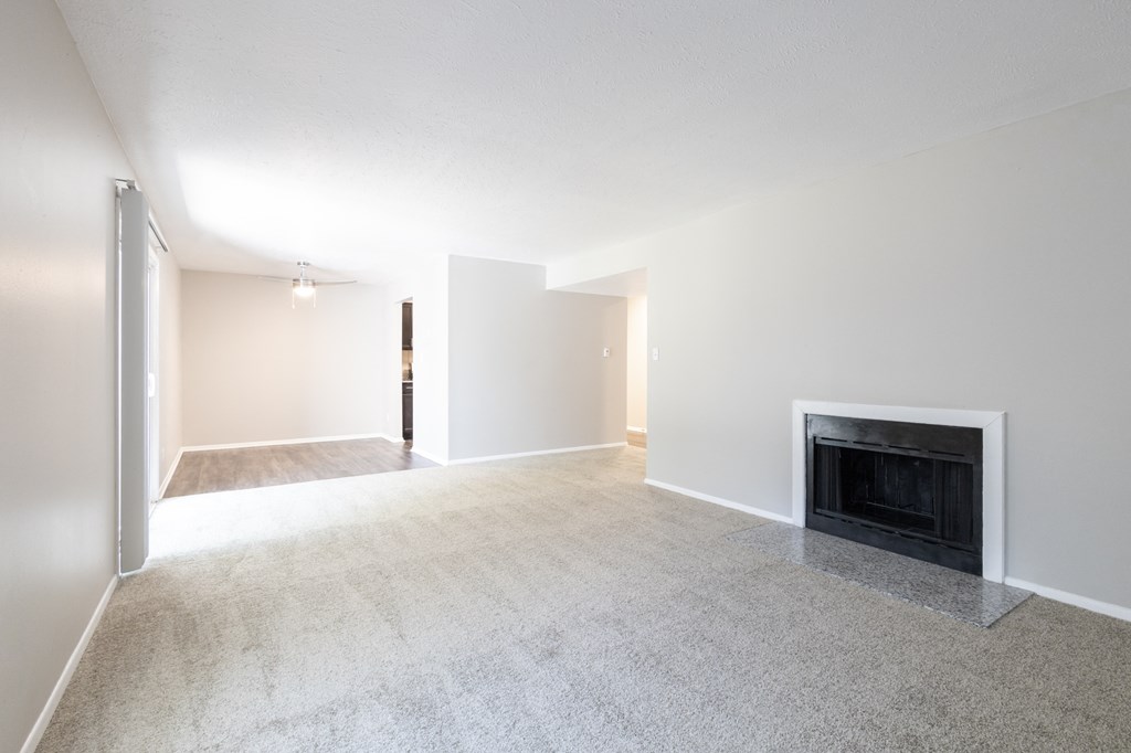 Open Dining and Living Room with a Fireplace in the Two Bedroom Two Bath Apartment at Woodbridge Apartments Bloomington