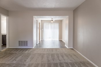 Dining Room with Patio Access and Living Room in the Two Bedroom Townhome at Woodbridge Bloomington - Photo Gallery 46