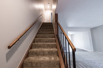 Stairway in the Two Bedroom Townhome at Woodbridge Apartments Bloomington - Photo Gallery 42