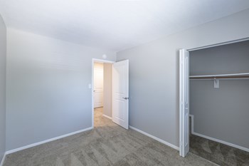 Second Bedroom with Ample Closet Space in the Three Bedroom Townhome at Woodbridge Apartments Bloomington - Photo Gallery 34