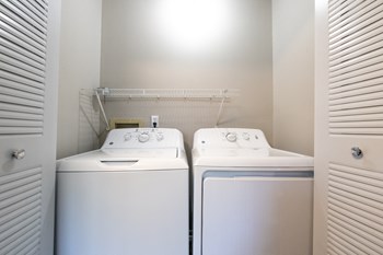 Laundry Area in the Three Bedroom Townhome at Woodbridge Apartments Bloomington - Photo Gallery 39