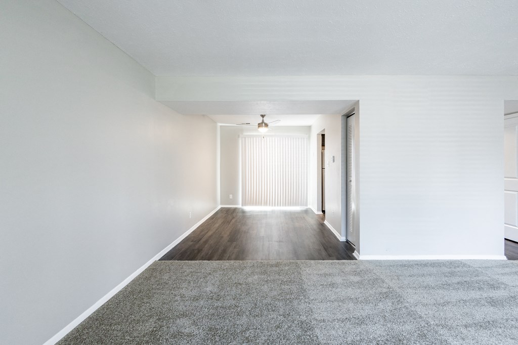 Dining Room with Patio Access and Living Room in the Three Bedroom Townhome at Woodbridge Apartments Bloomington