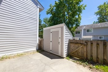 Enclosed Patio with Additional Storage in the Three Bedroom Townhome at Woodbridge Apartments Bloomington - Photo Gallery 36